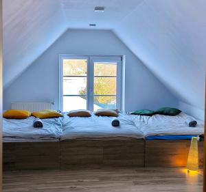 a bed in a room with a large window at AURA House in Krępa