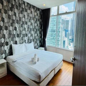 a bedroom with a bed with a teddy bear on it at Vortex by klcc view in Kuala Lumpur +80 photos