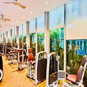 a gym with a row of treadmills and ellipticals at Vortex by klcc view in Kuala Lumpur