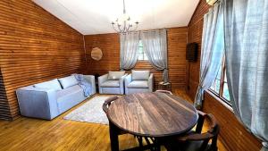 a living room with a table and a couch at Fairhaven Guest House in Klerksdorp