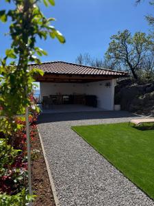 a garden with a pavilion with a grass yard at Villa Petra in Kastav