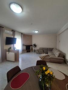 a large living room with a table and a couch at Karina in Carini