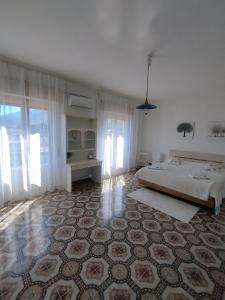 a bedroom with a bed and a large rug at Karina in Carini