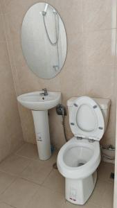 a bathroom with a toilet and a sink and a mirror at มุก&พลอย เรสซิเดนซ์ in Sattahip +8 photos