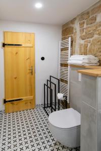 a bathroom with a toilet and a wooden door at Königův mlýn in Úštěk +44 photos