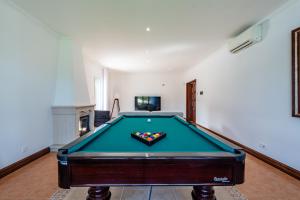 a pool table in the middle of a living room at Quinta da Lu - Azorean Villa in Ribeira Grande