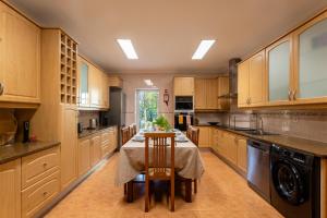 a large kitchen with a table and chairs in it at Quinta da Lu - Azorean Villa in Ribeira Grande