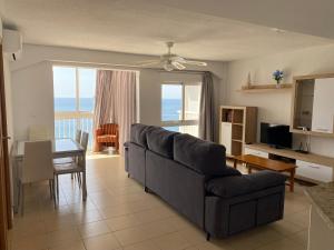 a living room with a couch and a table at Veracruz-Fincas Benidorm in Benidorm