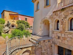 a stone building with a staircase in front of it at Villa Rosa in Cannigione +24 photos