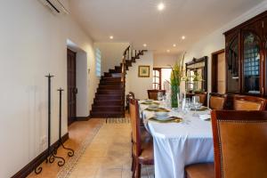 a dining room with a table and chairs at Quinta da Lu - Azorean Villa in Ribeira Grande