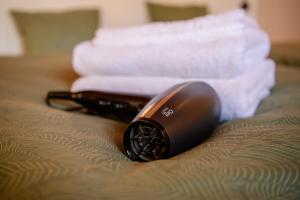 a hair dryer sitting on a bed with towels at Königův mlýn in Úštěk