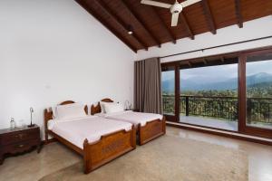 a bedroom with two beds and a large window at Villa Subashri, Victoria Golf Greens - Digana in Kandy