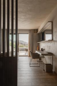a kitchen with a table and a desk in a room at Locanda MaMaGiò in Valdobbiadene