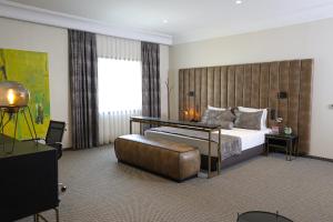 a hotel room with a bed and a large window at Hotel Rubis in Ferizaj +68 photos