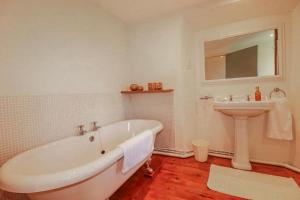 a bathroom with a bath tub and a sink at Poldue House in Camelford +27 photos