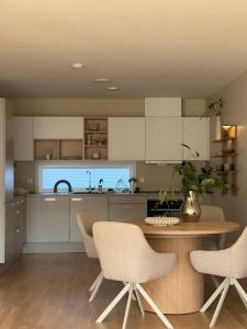 a kitchen with a table and chairs and a sink at Modern and stylish home in Bergen +17 photos