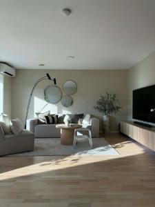 a living room with a couch and a tv at Modern and stylish home in Bergen