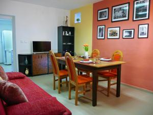 a living room with a dining room table and chairs at Prízemný apartmán Anika s veľkým parkovaním in Nitra