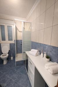 a bathroom with a toilet and a sink and a shower at GUESTHOUSE Kastel Novi 2 More Space in Kaštela +13 photos