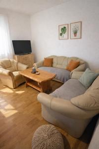 a living room with a couch and a coffee table at GUESTHOUSE Kastel Novi 2 More Space in Kaštela