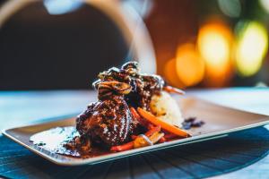a plate of food with meat and vegetables on a table at Hótel Eyjafjallajökull in Hvolsvöllur