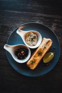 a blue plate of food with a sandwich and dips at Hótel Eyjafjallajökull in Hvolsvöllur +37 photos