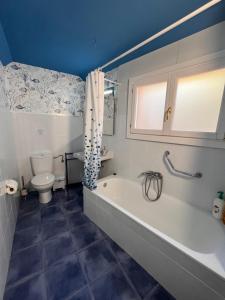 a blue bathroom with a tub and a toilet at AL SON DE LAS OLAS in Lastres +41 photos