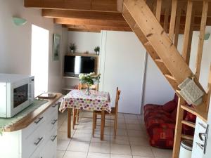 a small kitchen with a table and a microwave at Penty in Crozon