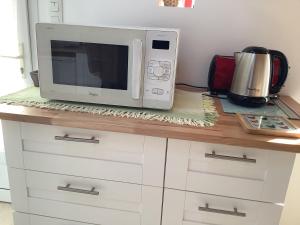 a microwave sitting on top of a kitchen counter at Penty in Crozon