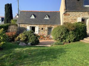 an old stone house with a garden in front of it at Penty in Crozon
