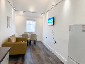 a living room with a couch and a table at Bletchley Retreat in Bletchley