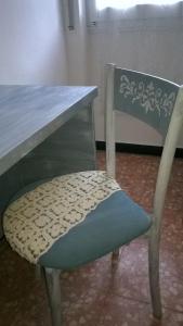 a wooden table with a chair next to a table with a bench at Bed Il Faro in Finale Ligure
