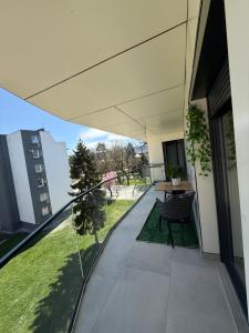 a balcony of a building with a table and chairs at Real Residence Bugojno in Bugojno