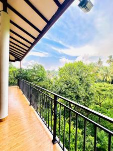 a balcony of a house with a view of trees at Kandy Grand Hill in Kandy
