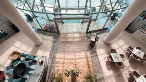 an overhead view of a lobby with a glass ceiling at Holiday Inn Abu Dhabi by IHG in Abu Dhabi