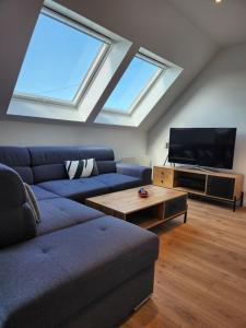 a living room with a couch and a flat screen tv at O'Phare Ouest in Plouguerneau