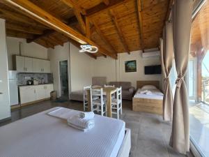 a bedroom with a bed and a kitchen and a table at Arthur's 4Apartments in Borsh