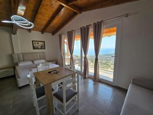 a bedroom with a table and a bed and a window at Arthur's 4Apartments in Borsh