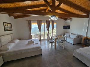 a living room with a bed and a table at Arthur's 4Apartments in Borsh