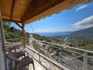 a balcony with chairs and a view of the ocean at Arthur's 4Apartments in Borsh