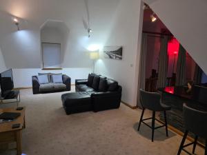 a living room with a couch and a chair at Letterfinlay Lodge House in Letterfinlay