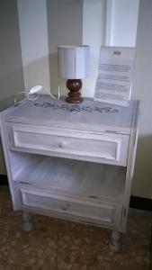 a white dresser with a lamp on top of it at Bed Il Faro in Finale Ligure