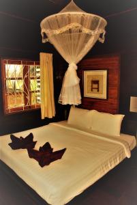 a bedroom with a bed with two bats on it at Cozy Garden Resort in Ao Nang Beach