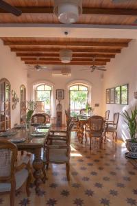 an open dining room with a table and chairs at The Postcard Saligao, North Goa in Calangute