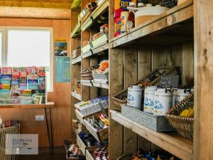 a store with shelves filled with food and other items at St Loy & Penberth Shepherds' Huts in Saint Buryan