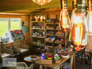 a store with tables and chairs in a room at St Loy & Penberth Shepherds' Huts in Saint Buryan