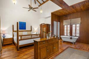 a large bathroom with a bed and a tub and a sink at The Postcard Saligao, North Goa in Calangute +119 photos