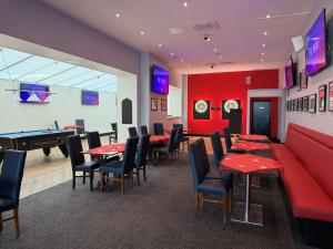 a restaurant with ping pong tables and a pool table at The Grand Hotel in Port Talbot