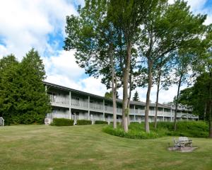 a building with a park in front of it at Country House Resort in Sister Bay