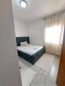 a small bedroom with a bed and a window at JJHomes in Eldoret +2 photos